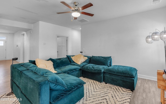 living room featuring ceiling fan and light hardwood / wood-style floors