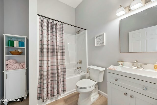 bathroom with shower / tub combo with curtain, toilet, vanity, wood finished floors, and baseboards