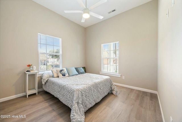 bedroom with baseboards, visible vents, and light wood-style floors