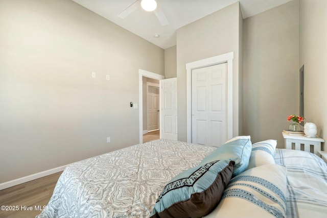 bedroom with ceiling fan, a closet, baseboards, and wood finished floors