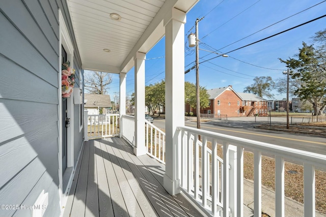 deck featuring a porch and a residential view