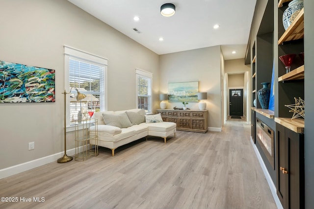 sitting room featuring light wood-type flooring, baseboards, visible vents, and recessed lighting