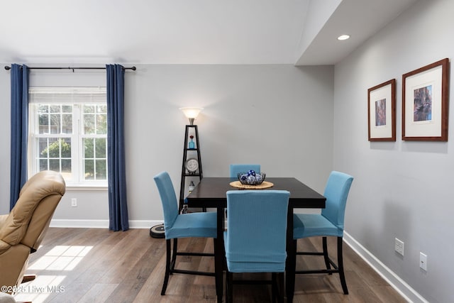 dining space with dark wood-type flooring