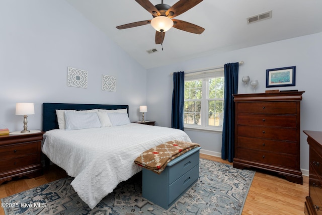 bedroom with ceiling fan, vaulted ceiling, and light hardwood / wood-style floors