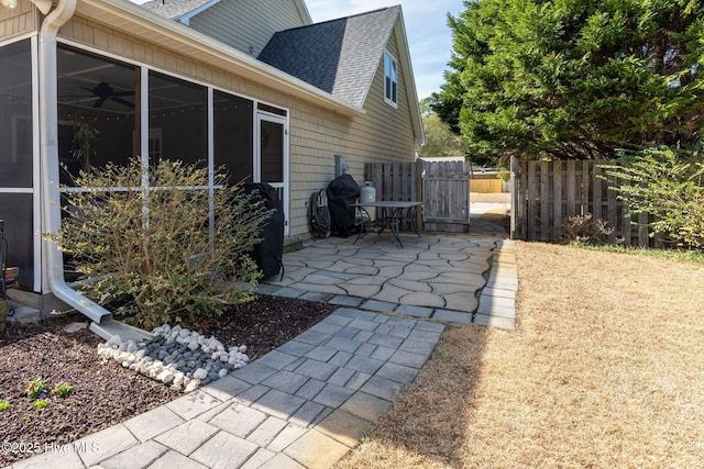 view of home's exterior with a patio area and a sunroom