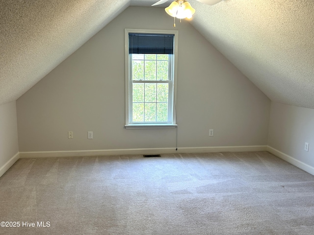 6237 Sentry Oaks Dr, Wilmington, NC 28409 - bonus room with a textured ceiling, a ceiling fan, carpet flooring, lofted ceiling, and baseboards