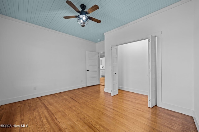 unfurnished bedroom featuring wood ceiling, baseboards, a ceiling fan, light wood-style floors, and ornamental molding