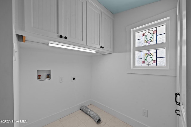 laundry room featuring washer hookup, cabinet space, hookup for an electric dryer, light tile patterned flooring, and baseboards