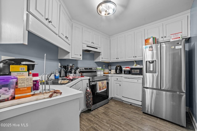 kitchen featuring under cabinet range hood, stainless steel appliances, a sink, white cabinets, and light countertops