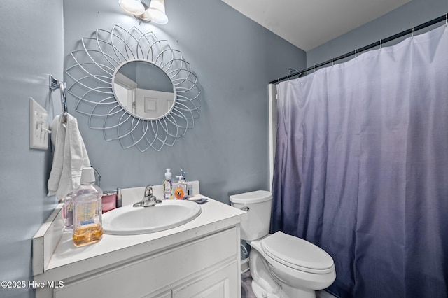 bathroom with toilet, curtained shower, and vanity