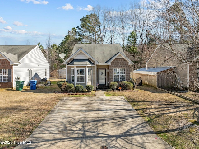 view of front of house with a front lawn and brick siding