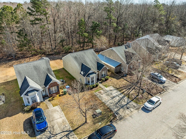 birds eye view of property with a wooded view