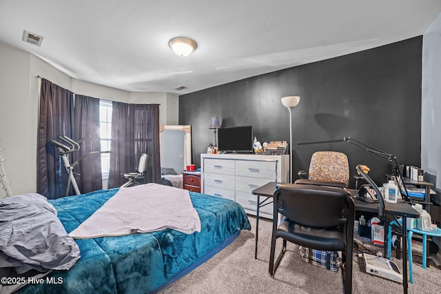 bedroom featuring light colored carpet and visible vents