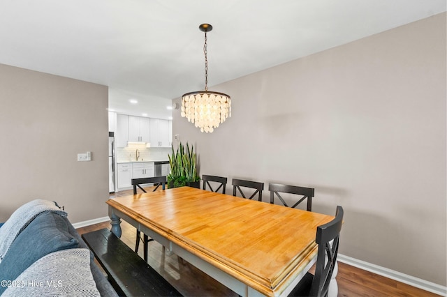 dining room featuring an inviting chandelier, baseboards, dark wood finished floors, and recessed lighting