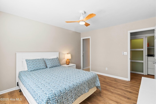 bedroom featuring a ceiling fan, baseboards, and wood finished floors