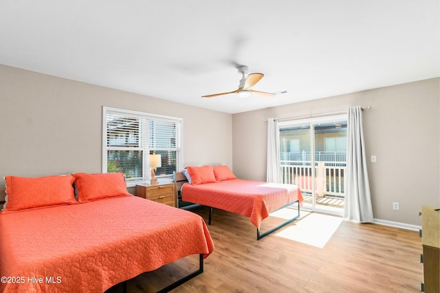 bedroom with light wood finished floors, access to outside, multiple windows, and baseboards