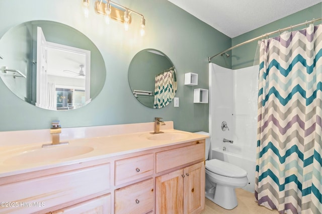 bathroom featuring double vanity, shower / tub combo, toilet, and a sink