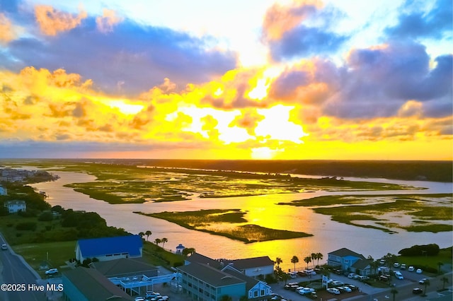 aerial view at dusk with a water view