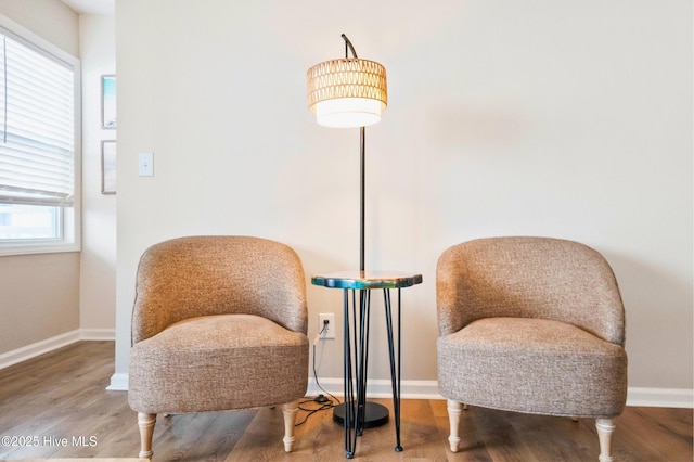 sitting room featuring baseboards and wood finished floors