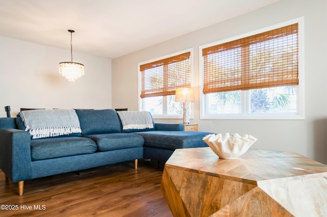 living area with a notable chandelier and wood finished floors