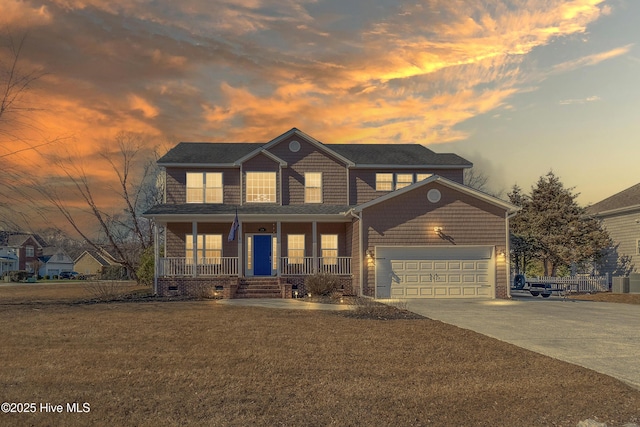 view of front facade with a garage, a lawn, and a porch