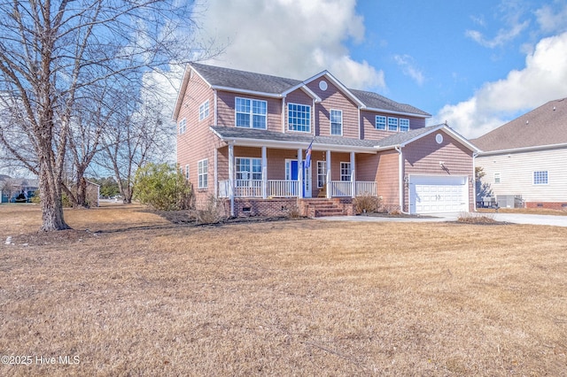 view of front facade with a front yard, a garage, and a porch