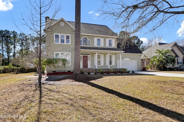 colonial-style house featuring an attached garage, concrete driveway, crawl space, a front lawn, and a chimney