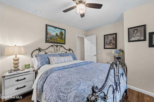 bedroom featuring ceiling fan, dark wood-style flooring, and baseboards