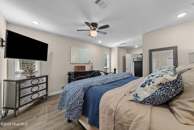 bedroom featuring ceiling fan, recessed lighting, wood finished floors, visible vents, and baseboards