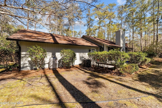 view of property exterior with a chimney