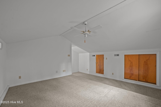 bonus room featuring visible vents, baseboards, a ceiling fan, lofted ceiling, and light colored carpet