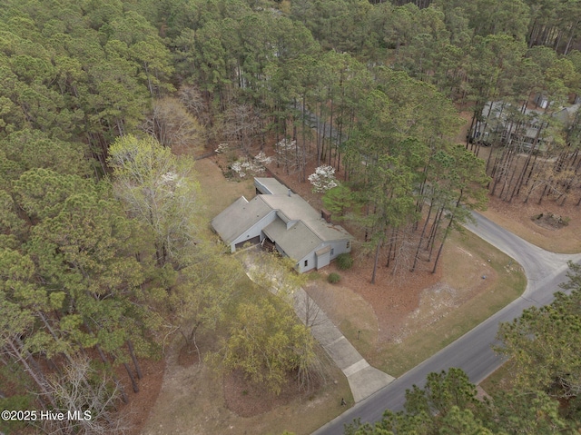 birds eye view of property featuring a view of trees