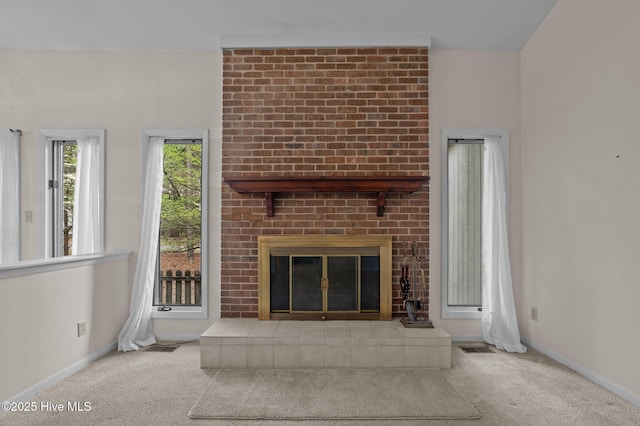 unfurnished living room with baseboards, carpet flooring, and a brick fireplace