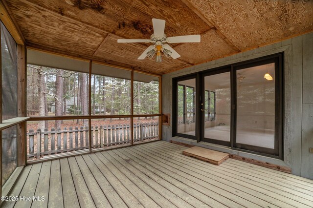 unfurnished sunroom with a ceiling fan