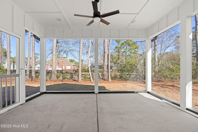 unfurnished sunroom featuring ceiling fan