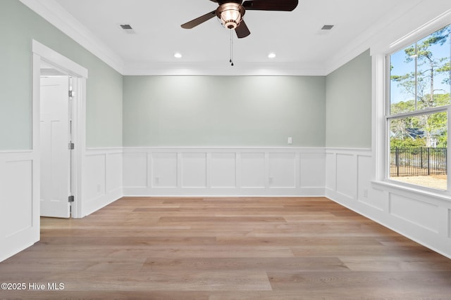 unfurnished room featuring crown molding, ceiling fan, and light hardwood / wood-style flooring