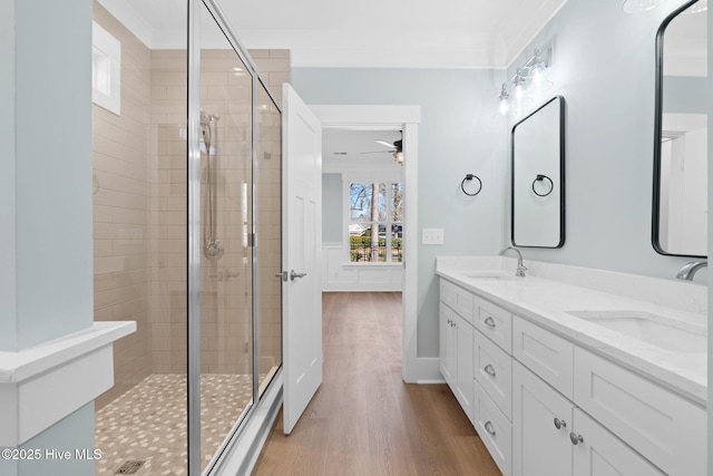 bathroom featuring vanity, wood-type flooring, and walk in shower