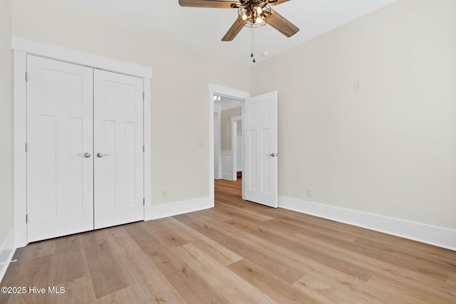 unfurnished bedroom with ceiling fan, light hardwood / wood-style flooring, and a closet