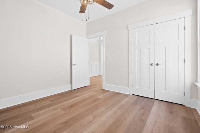 unfurnished bedroom featuring light wood-type flooring, a closet, and ceiling fan