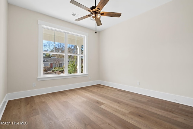 spare room featuring light wood-type flooring and ceiling fan