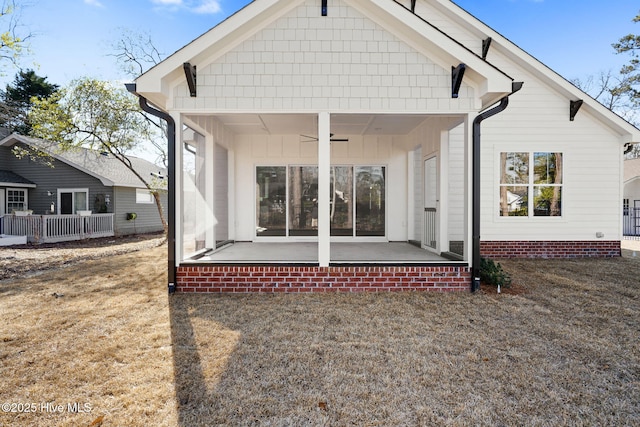 back of property featuring ceiling fan