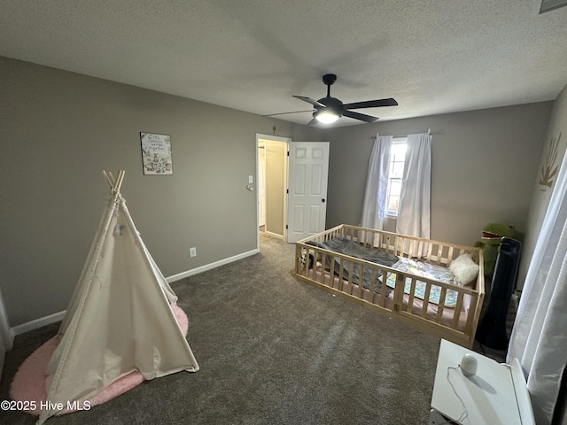 rec room with baseboards, a textured ceiling, and carpet flooring