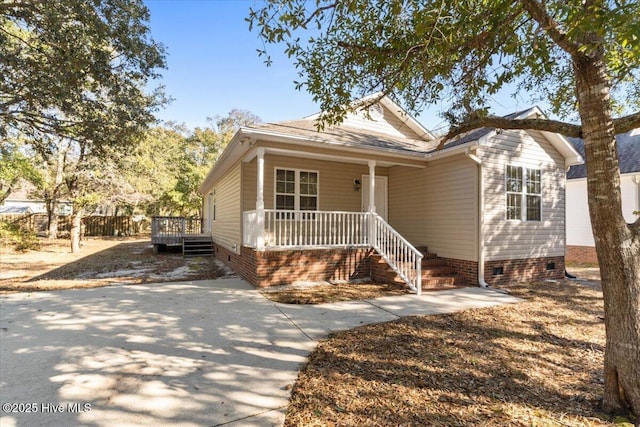 view of front of property featuring crawl space and fence