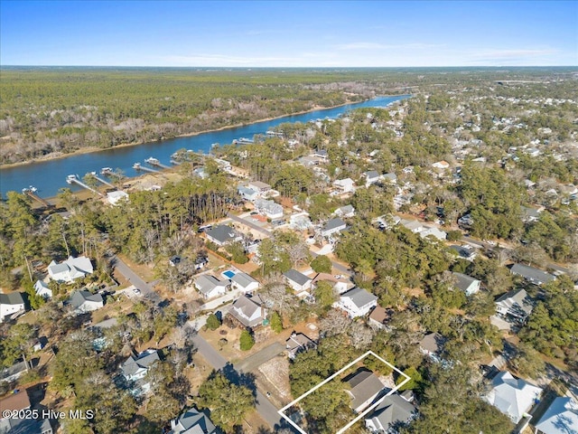 birds eye view of property with a water view, a residential view, and a view of trees