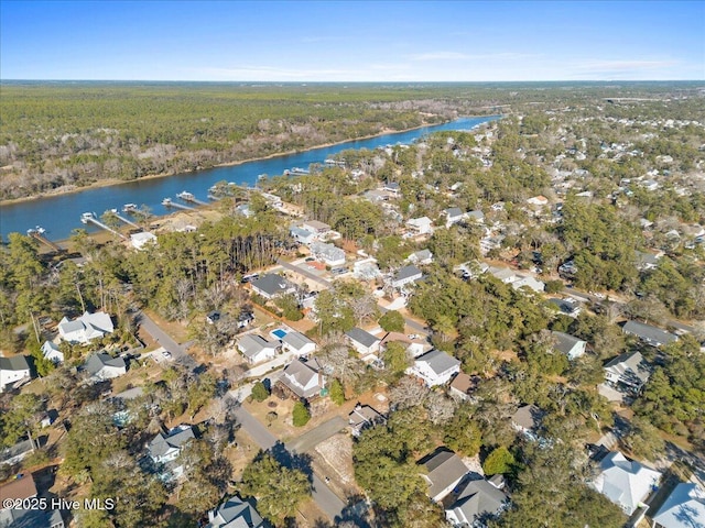 birds eye view of property featuring a water view, a residential view, and a view of trees