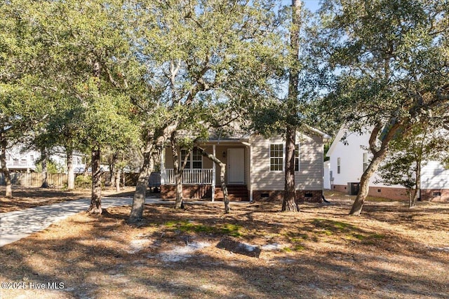 view of front of house with a porch, crawl space, and fence