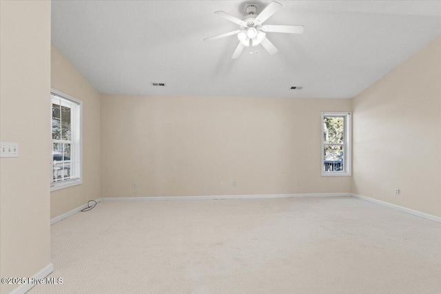 unfurnished room featuring light carpet, baseboards, visible vents, and ceiling fan