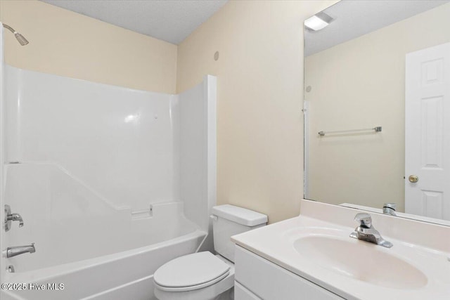 full bath with toilet, shower / washtub combination, a textured ceiling, and vanity