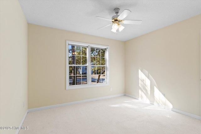 unfurnished room featuring a textured ceiling, baseboards, and light colored carpet