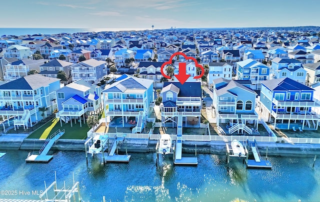 birds eye view of property featuring a residential view and a water view